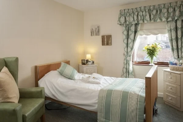 A calm, softly lit resident's bedroom