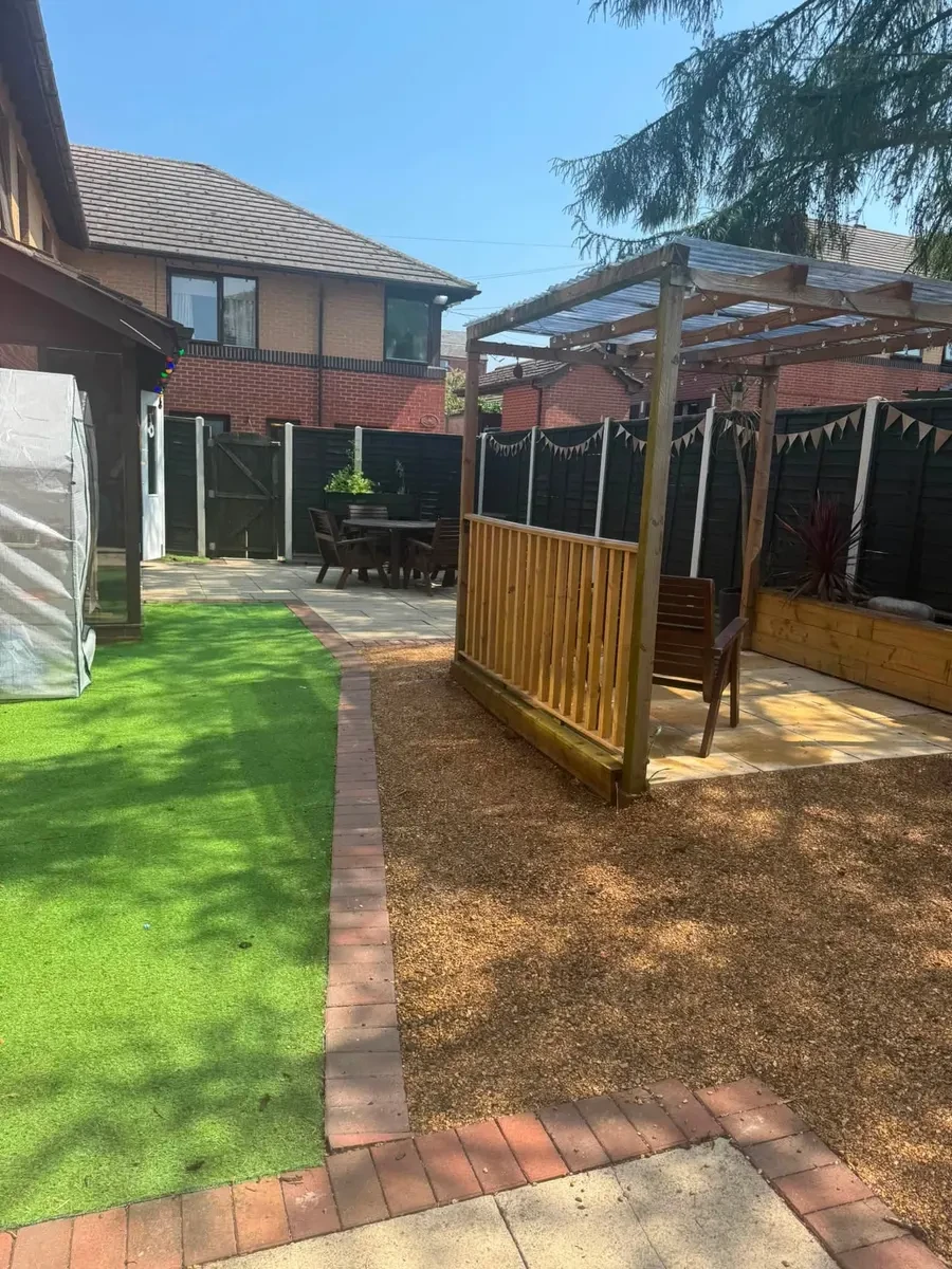 A sunny, sheltered garden with a pergola, seating and artificial lawn