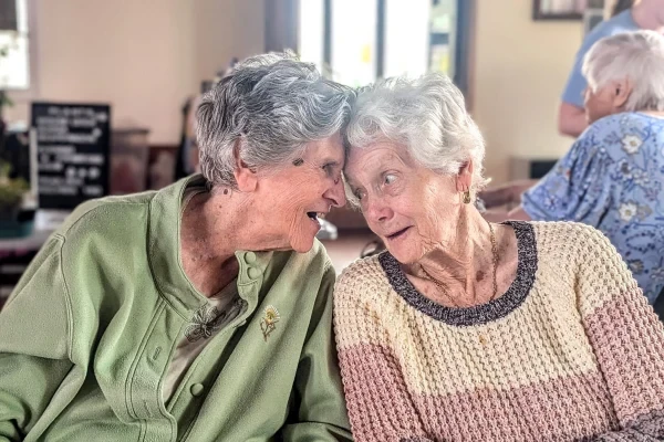 Two residents sharing a laugh together